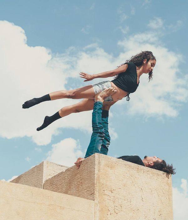 Man performing a controlled bodyweight exercise in a minimalist setting.