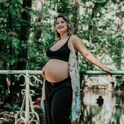 Portrait of a smiling woman, the program guide, in a calm, natural setting.
